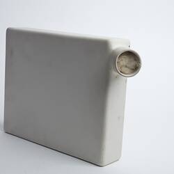 White rectangular ceramic container with cylindrical spout/opening at top right.