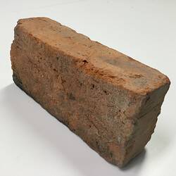 Red clay bric showing rough underside.