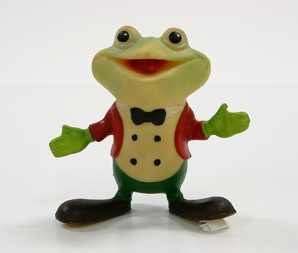 Coloured plastic toy frog, standing upright.