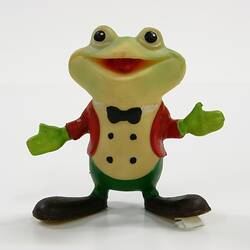 Coloured plastic toy frog, standing upright.