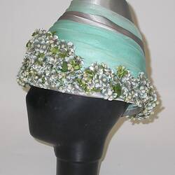 Layered green and grey hat with flowered brim.