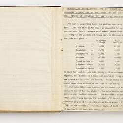 Open book with off white pages. Typed text on right side.