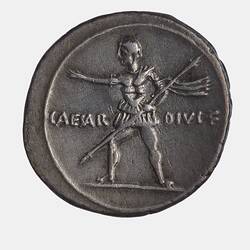 Round coin with standing male figure in military dress advancing left with a spear.