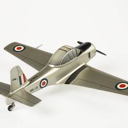 Model aeroplane, silver with black propeller and wheels. Red, white, blue roundels on wings, body and flag on tail.