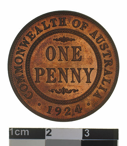 Round medal with central text and text around.