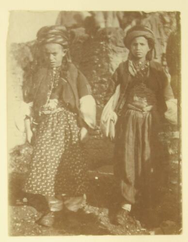 two Kurdish children in traditional clothing.