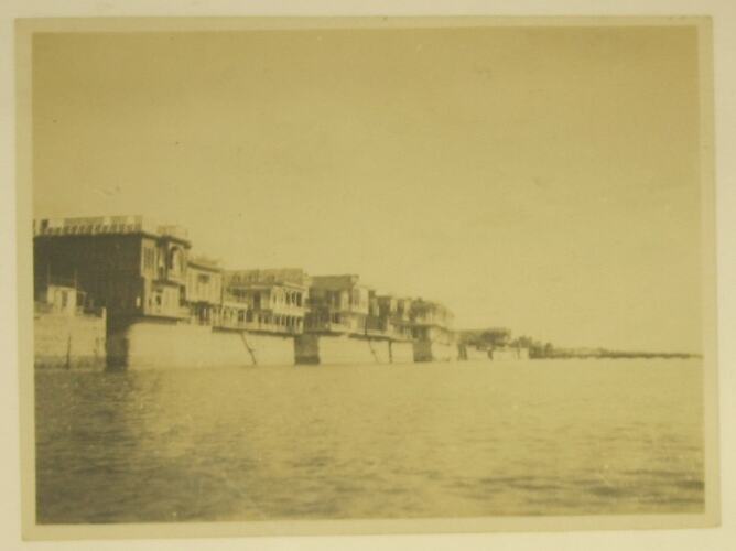 Two storey buildings on bank of Tigris river.