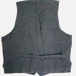 Back of grey waistcoat with adjustment strap.