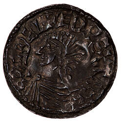 Coin, round, bust of the King wearing armour facing left, the base of the bust reaches the edge of the coin.