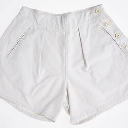 White shorts with four buttons down right side.