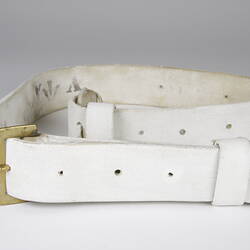 White leather sling with brass buckle.