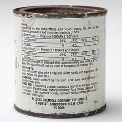 White tin with rusted lid. Black printing on label.