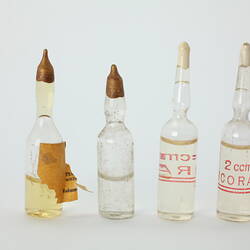 Four clear glass bottles