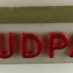 White sign with red letters that spell MUDPAC.