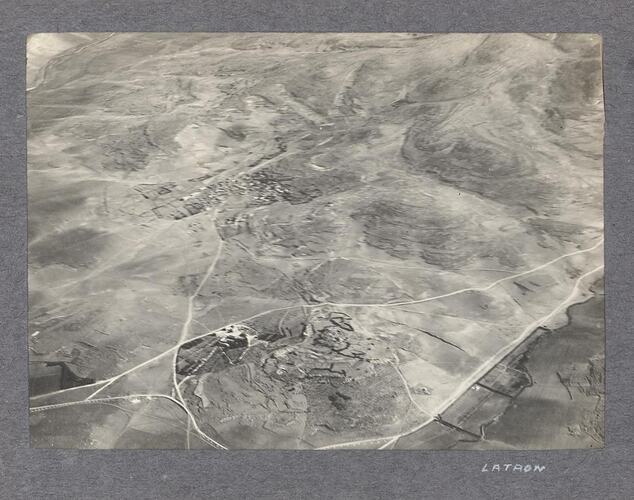 Aerial view of two settlements, surrounded by open land.