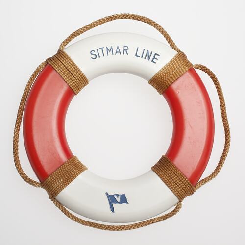 Red and white lifebuoy with brown cord.
