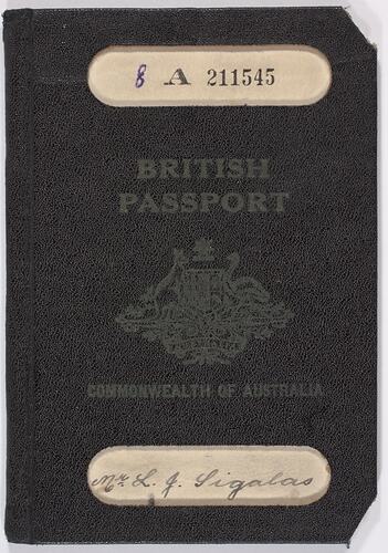Dark blue passport front cover with gold printing. Coat of arms in centre. Cut out strip top and base.