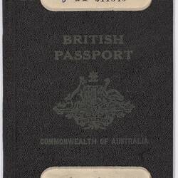 Dark blue passport front cover with gold printing. Coat of arms in centre. Cut out strip top and base.