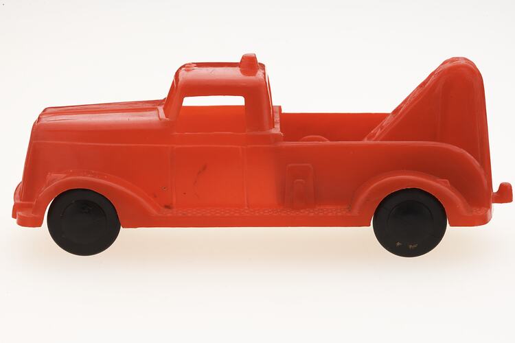 Red plastic toy truck.