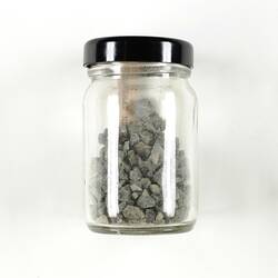 A jar of containing bits of rock.