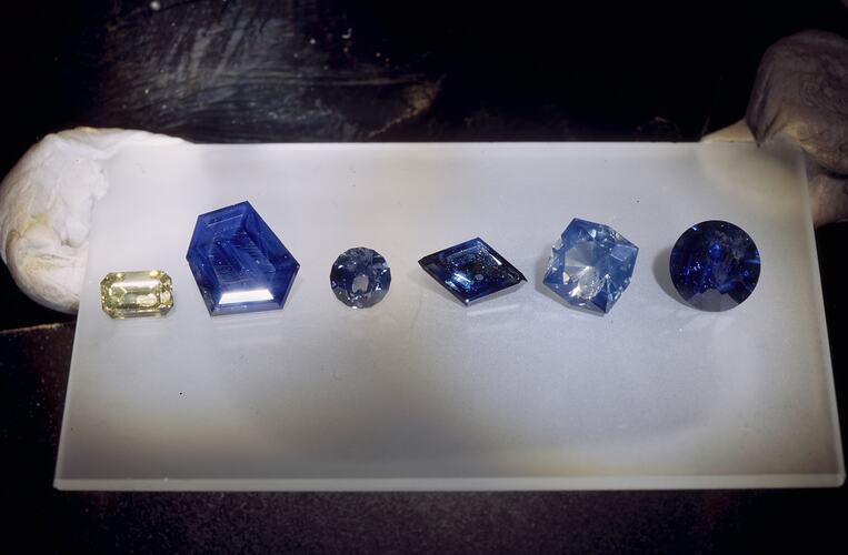 Six cut sapphires in a row.