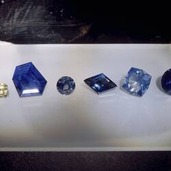Six cut sapphires in a row.