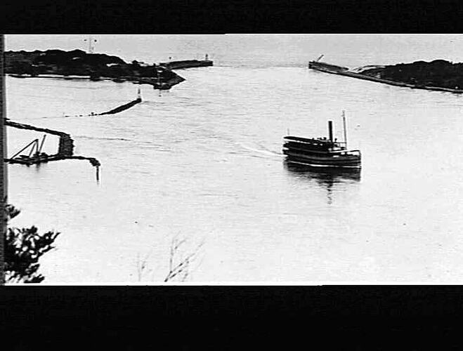 [The Gippsland on the Gippsland Lakes, Lakes Entrance, about 1931. The artificial entrance between the lakes and the ocean is visible in the background.]