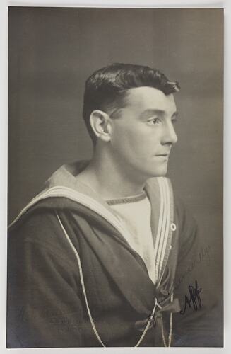 Studio portrait of a man in Navy uniform.