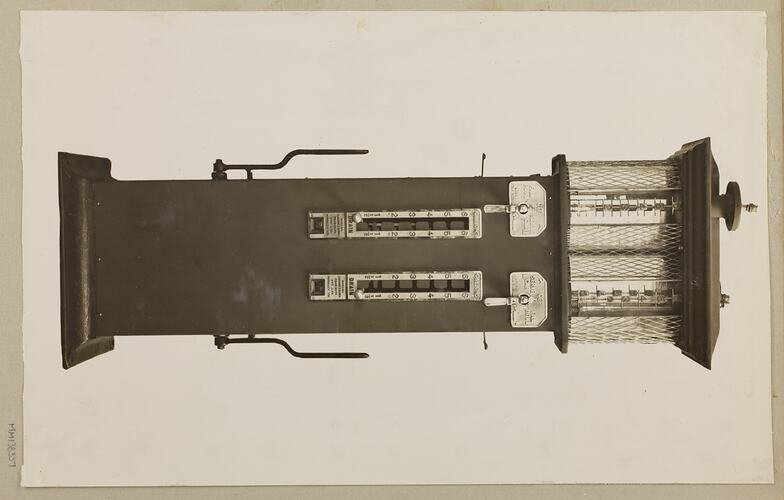 Monochrome photograph of a twin cylinder petrol pump.