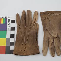 Pair of mid-brown cotton gloves with colour chart