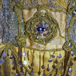 Detail of golden dress showing waist beading.