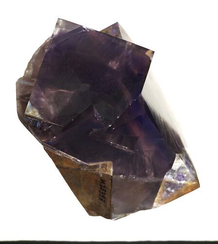 Purple and brown mineral with square crystal shapes.
