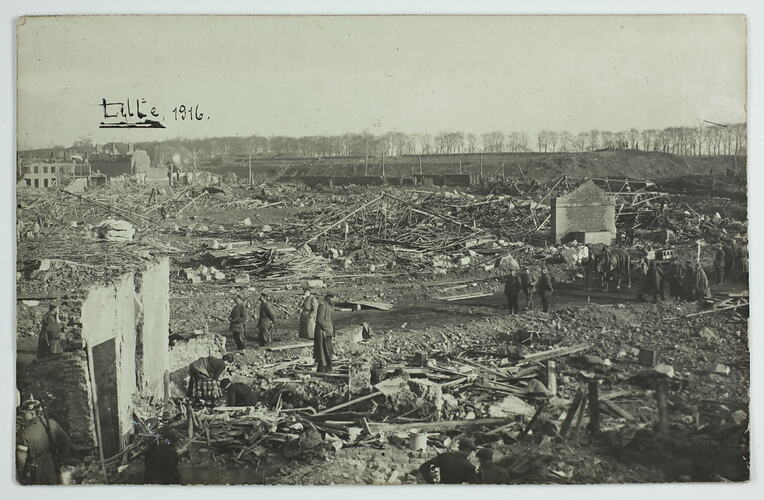 German soliders and civilians in damaged city.