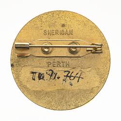 Back of round metal pin badge.