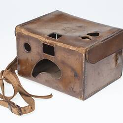Back of tan leather camera carry case with strap. Cut out sections.