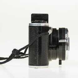 Black camera with metal trim. Wrist strap. Right profile.