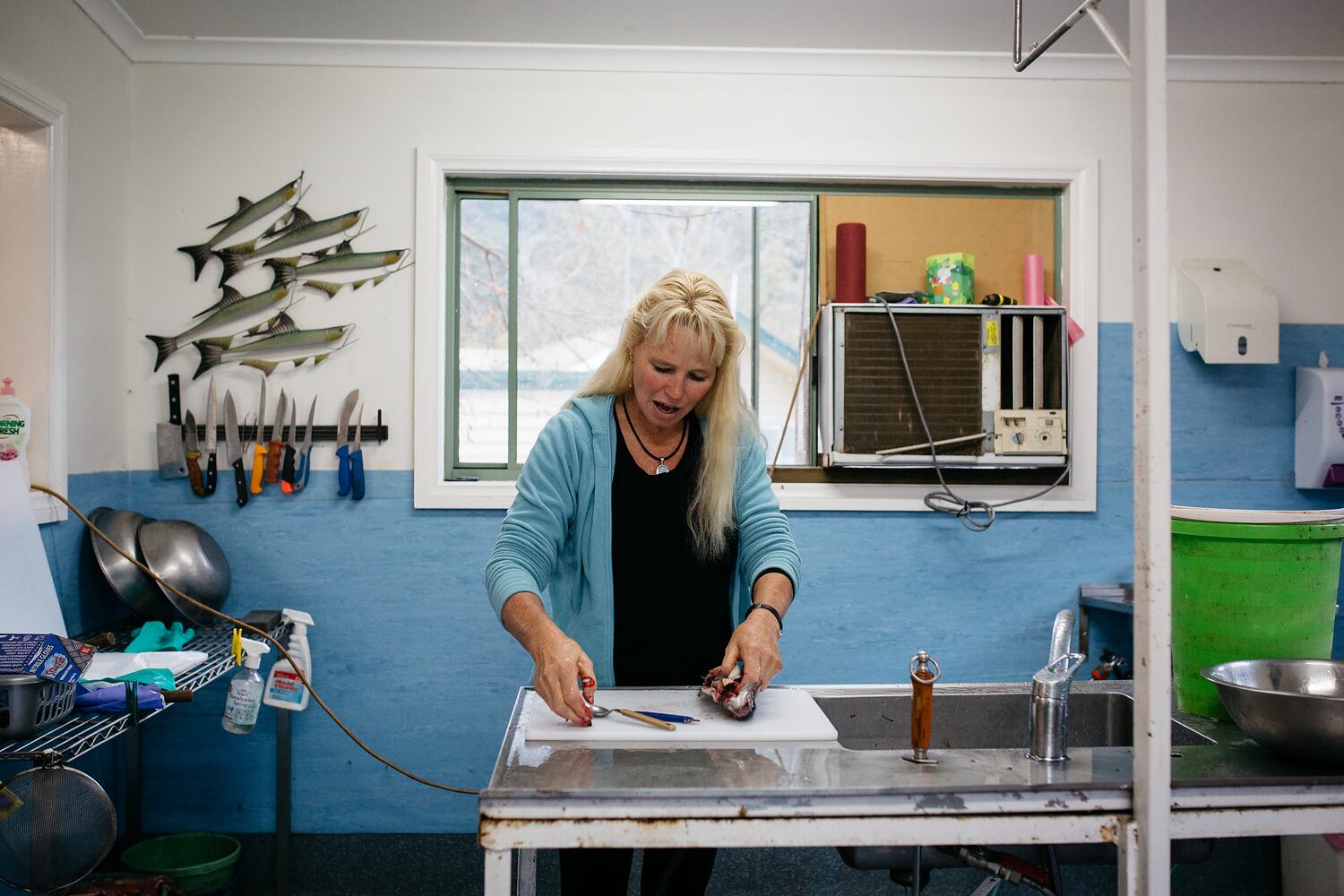 Digital Photograph Trout Farmer Sally Hall Filleting a Fish