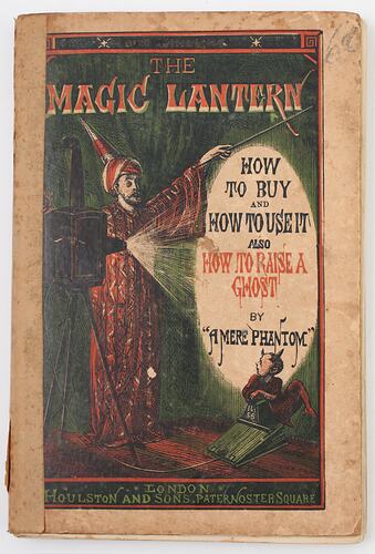 Magician using a magic lantern with an imp as an assistant.