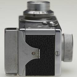 Side of a miniature metal camera.