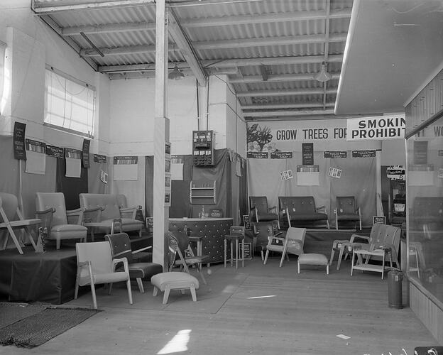 Furniture showroom with chairs, couches, stools and a bar covered in vinyl.
