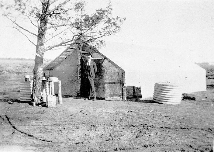 [A.L. Martin beside his first home on the soldier settlement block number 332, Redcliffs, 1922.]