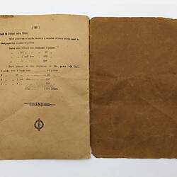 Open booklet with worn off-white pages and black printed diagrams and text.