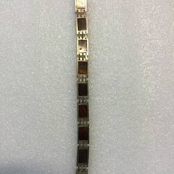 Underside of silver bracelet made of hand-made links. Open.