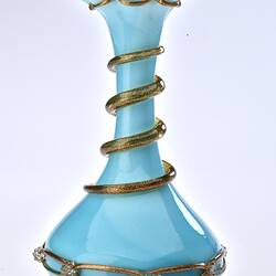 Pale opaque blue glass vase with gilded ribbon spiralling from base up to top. Flared neck with frill at top.