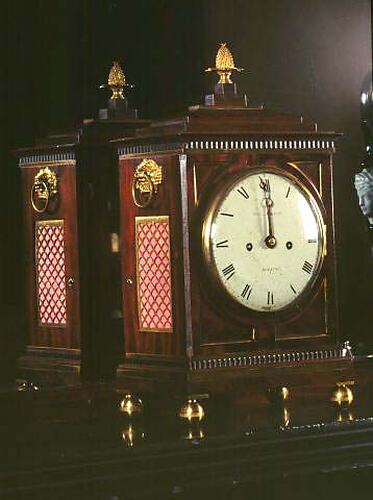 Brown wooden clock set to midnight.