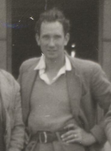 Man standing on worksite with his hand on his hip.