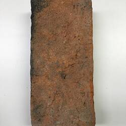 Rough side of red clay brick.