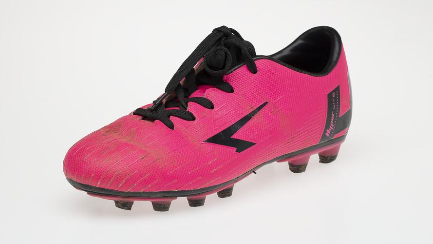 Pink Australian Rules football boot with black bootlace, inner sole and sole.