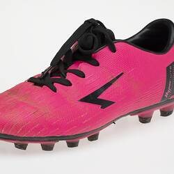 Pink Australian Rules football boot with black bootlace, inner sole and sole.