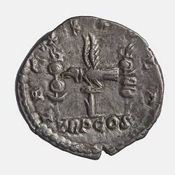 Roughly round silver coin. Eagle between two standards. Text around.